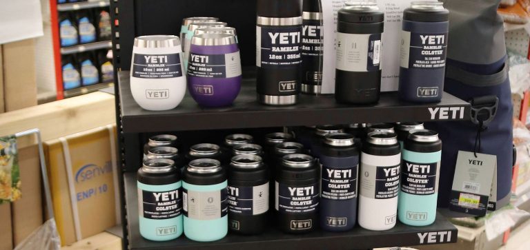 A display stand featuring a variety of Yeti travel mugs